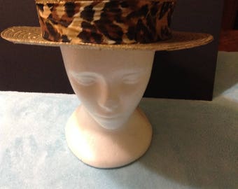 Vintage golden straw boater hat with an attached leopard print headband, wide brim.