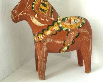 Swedish wooden Dala Horse painted red with traditional 'kurbits' decorative detail