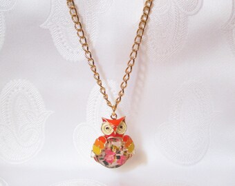 Here is a long necklace with a gold OWL and her floral belly!
