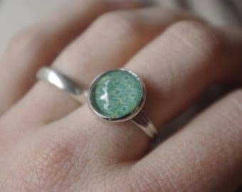 Blue-green ring with a glass cabochon