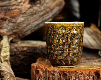 Stoneware Cup with peach stone imprints in fluid woodash glaze