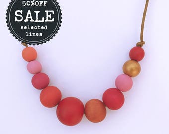 reds, pinks and gold hand painted wooden bead necklace