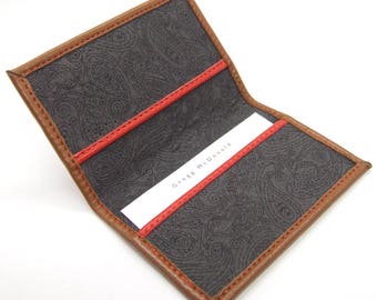 Tan leather card holder, paisley lining, red details