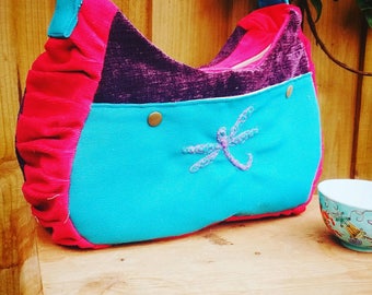 Fabric dragonfly crossbody bag/shoulder bag in a boho shape in bright pink, turquoise + deep purple with zip fastening and adjustable strap