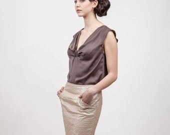straight skirt is ruffled with overstitched pockets gold fabric