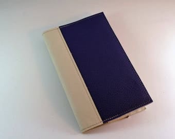Pocket moleskine notebook has cream and purple