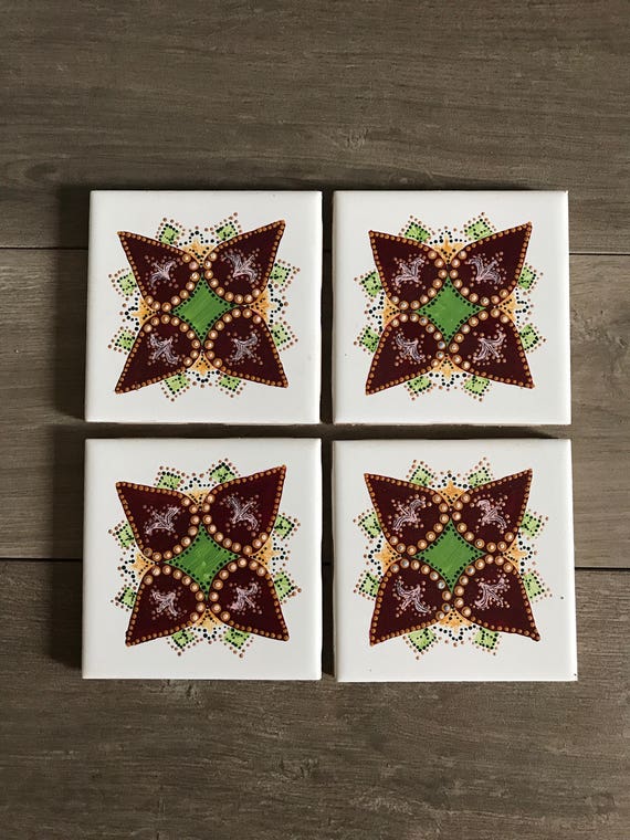 Set of four beautiful hand painted ceramic coasters