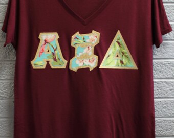 Alpha Xi Delta Maroon Bella Flowy V-Neck With Amy Butler Bliss Bouquet on Gold Metallic (254C)