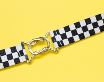 Skinny black and white checkerboard elastic waist belt with interlocking clasp