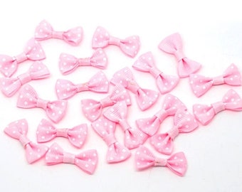 Pink satin bow with white polka dots