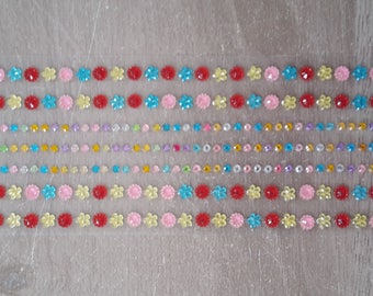 Round rhinestones and multicolored flowers