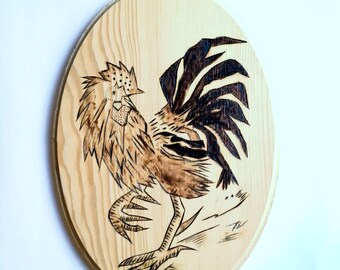 Pyrography on wood with a small fighting cock