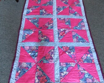 Quilt, pinks and blues, pinwheel style. 48x74