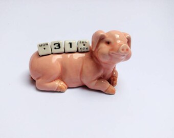 Vintage porcelain pig perpetual calendar