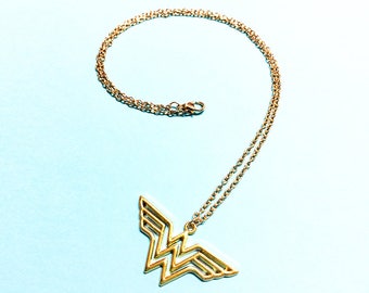 Wonder Woman Necklace - Gold logo shaped pendant charm. Super hero jewelry. Gold Wonder Woman Necklace. Beautiful, minimal necklace.