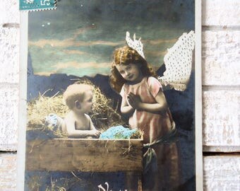Antique nativity postcard - Christmas Jesus crib hay, little girl angel wings, stars Bethlehem, sky night evening, french hand tinted, 1900
