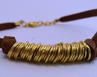 Leather bracelet and golden rings