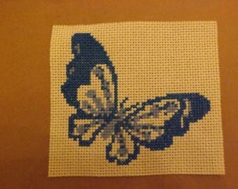 Blue butterfly embroidered on unbleached canvas