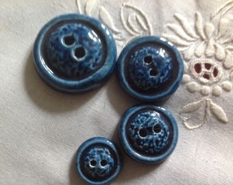 Set of four round ceramic buttons