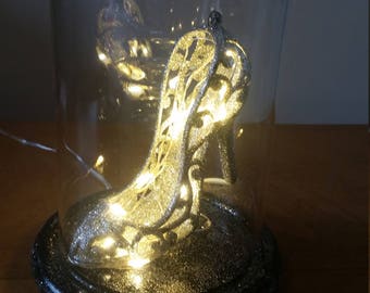 Cinderella inspired glass slipper dome light with battery operated LED lights. Glass dome on a wooden Base.
