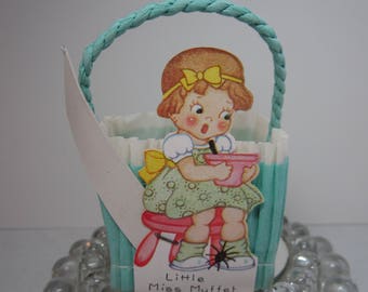 Vintage 1930's blue and white crepe paper nut candy cup party favor basket with die cut image of Little Miss Muffet nursery rhyme character