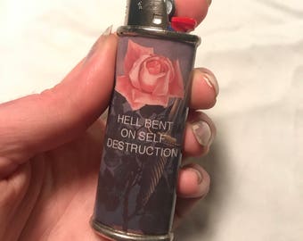 Reusable lighter case with TFB lyrics and Rene Magritte design