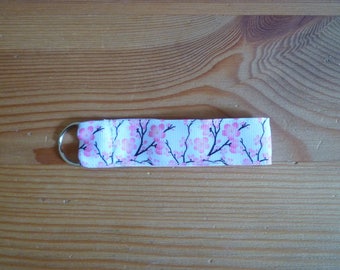 Key ring, pink flowers on white background