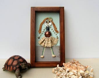 Small unique figurines made of antiques. Wall frame, girl's room.