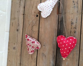 3 little hearts in red tissue Garland