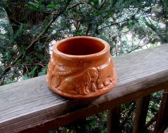 antique stoneware dog bowl with embossed dogs
