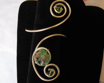 Gold arm bracelet and glass beads