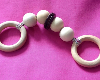 Wooden rattle and teether in her pouch.