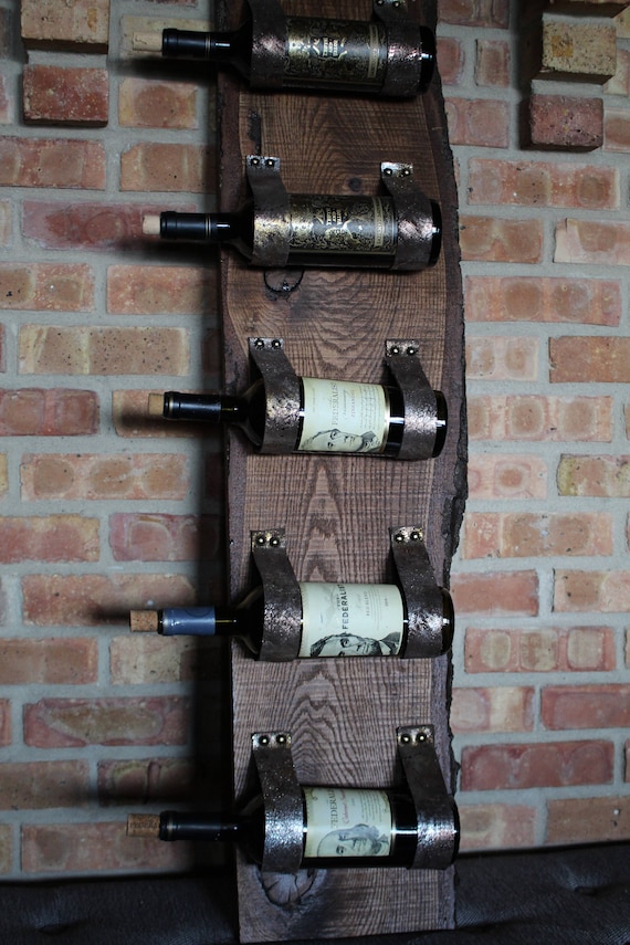 Live edge wood wine rack with metallic leather straps wall