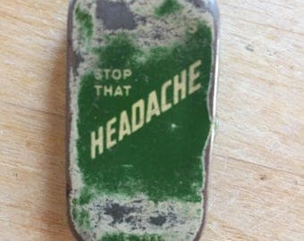 Tiny Tin with "Stop that Headache" on it.