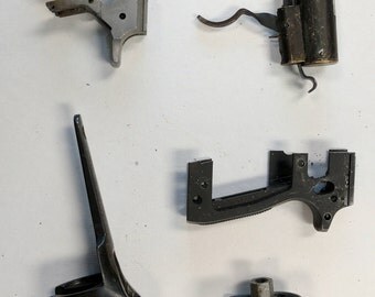 Gun parts from guns that have been taken off the streets and are now repurposed for art supplies