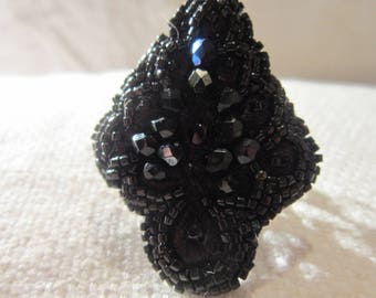 Black embroidered ring, unusual shape