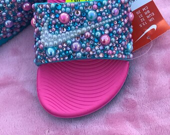 pink and blue nike slides