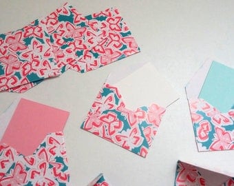 Set of small blue envelopes with pink butterflies
