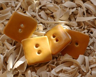 1 set of 4 square buttons saffron yellow