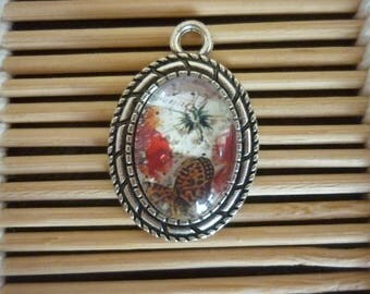 Ribbed silver pendant, cabochon oval glass poppy and butterfly.