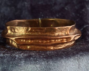 A unique handmade hammered polished copper bracelet.