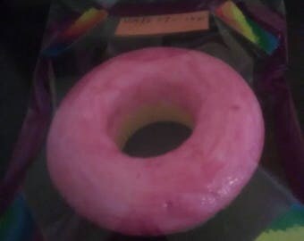 Yellow cake doughnut with pink frosting