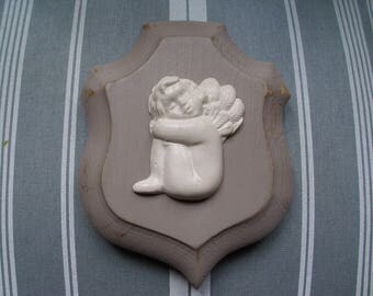 Angel plaster on wooden plaque
